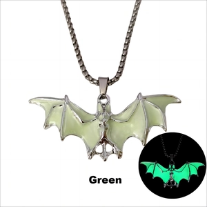 Détail montrant l'effet vert lumineux du pendentif chauve-souris sur chaîne acier