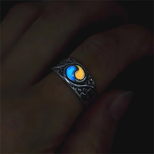 Detailed view of dual-color luminous yin-yang ring showing glowing blue and orange light