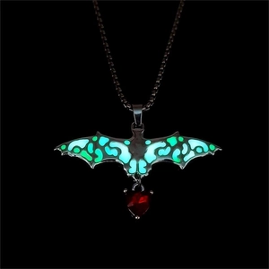 Detailed view of gothic luminous bat pendant with glowing wings and red heart crystal