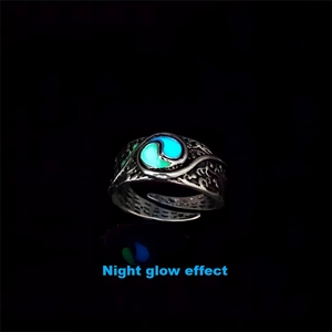 Macro shot of glow-in-the-dark rotating ring featuring embossed Tai Chi patterns on band