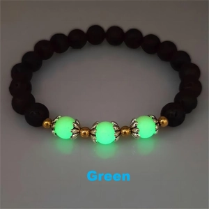 Macro shot of luminous green beads and volcanic stones on a lotus charm bracelet