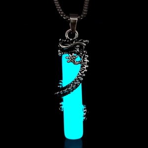 Detailed view of glow-in-the-dark blue pendant with intricate silver dragon wrap