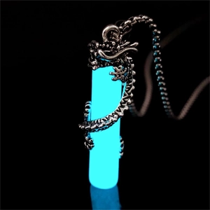 Detailed macro view of glow in the dark blue cylinder dragon pendant necklace for men