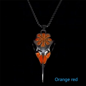 Detailed view of Viking bird skull pendant with glowing red eyes and Nordic runes