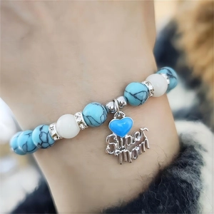 Detail of beaded bracelet with blue turquoise beads and Super Mom heart pendant