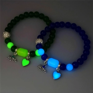 Luminous Mother's Day beaded bracelets showing a vibrant glow with heart and Mom charms