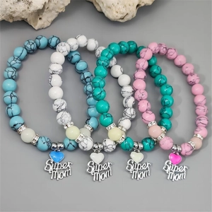 Detail of four-piece beaded bracelet set with Super Mom charms and heart pendants