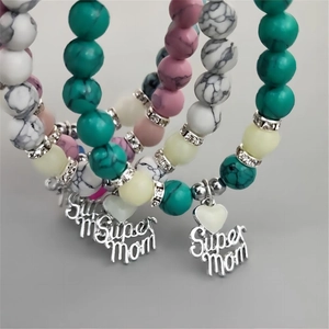 Detailed view of Super Mom beaded bracelets with turquoise and luminous glow heart charms