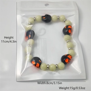 Macro detail of Halloween skull bracelet with glow-in-the-dark beads in retail packaging