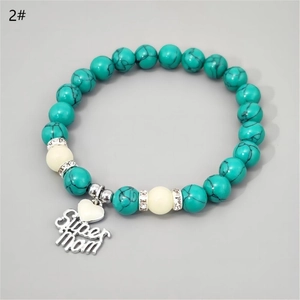 Macro view of Super Mom turquoise beaded bracelet with luminous heart pendant