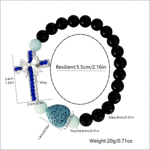 Bracelet croix lumineux avec pierre de lave en cœur et ornement nœud en strass bleu