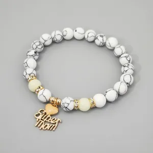 Detail view of heart-shaped charm with Super Mom text on marble bead bracelet