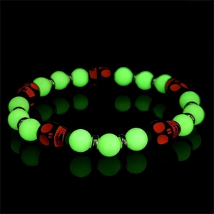 Glow in the dark beaded bracelet with bright green luminous skulls for Halloween