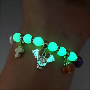 Luminous Halloween beaded bracelet with glowing skull, cross, and pumpkin charms