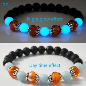 Luminous pumpkin glass bracelet with volcanic stone beads showing night and day effect