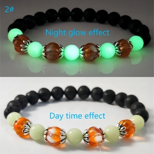 Halloween pumpkin glow bracelet showing day and night contrast with lava stone beads
