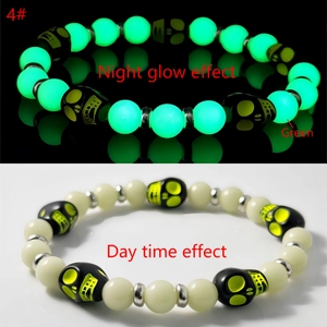 Luminous skull stretch bracelet showing bright green glow effect in dark vs day view