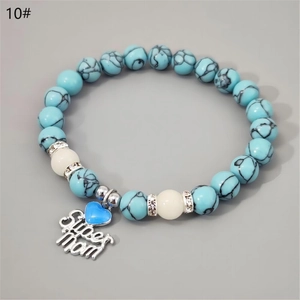 Detail of beaded Super Mom bracelet with turquoise texture beads and blue heart charm
