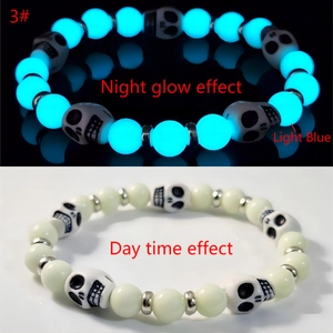 Luminous Halloween skull bead bracelet showing daylight and light blue night glow effect