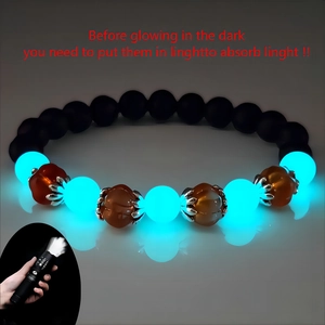 Luminous Halloween pumpkin glass bead bracelet with volcanic stone in dark environment