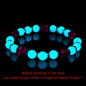 Luminous Halloween skull bracelet with glowing blue beads and purple skull charms