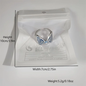 Luminous butterfly open ring with blue bead detail in clear packaging presentation