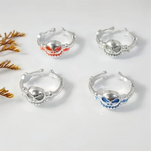 Set of four glow-in-the-dark skull rings with colorful enamel details for Halloween