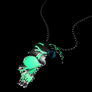 Gothic luminous skull necklace with glowing green detail and blue glass eye on black chain
