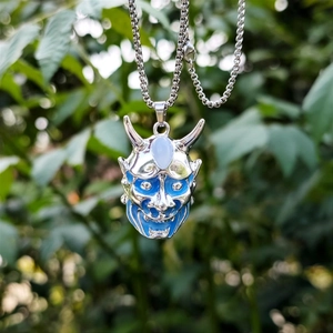 Dettaglio della collana maschera demone hip-hop con smalto blu e pietra incastonata