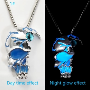 Luminous punk skull necklace with green eye stone showing day and night glow effects