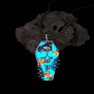 Gothic luminous coffin pendant necklace with glowing blue skull and orange flowers