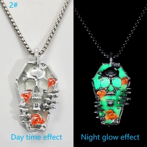 Luminous coffin pendant necklace with skull and red roses showing day and night glow effect