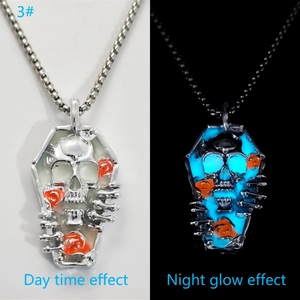 Macro view of luminous skull coffin necklace with glowing blue effect in the dark