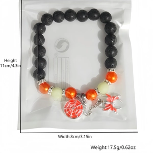 Luminous Halloween spider bracelet detail with volcanic stone beads and red enamel charms