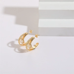 Elegant gold C-shaped hoop earrings with woven chain texture and opal heart stone