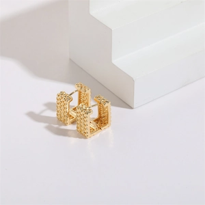 Detail of square gold hoop earrings featuring an intricate woven hollow texture design