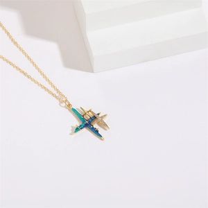 Detail view of the star-shaped gold necklace with blue gradient enamel and zircon inlay