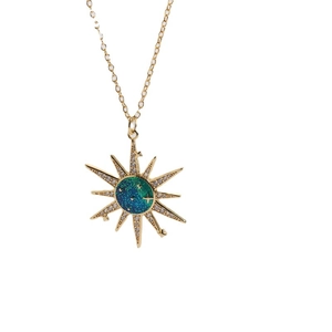 Golden sunburst star pendant necklace with celestial blue enamel and zircon inlay