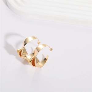 Exaggerated knotted gold hoop earrings with irregular twisted metal design for women