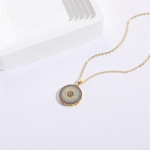 Luxurious gold plated evil eye pendant necklace with colorful zircons on white background