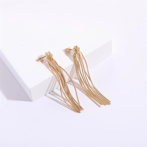 Detailed close-up of 14K gold-plated snake chain tassel earrings on a white stand