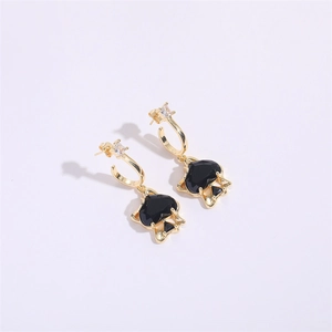 Close-up of black spade zircon earrings with gold hook and square crystal stud details