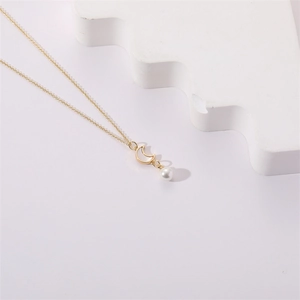 Elegant gold necklace with crescent moon shell pendant and round pearl detail charm