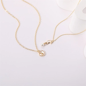 Layered gold necklace set with heart lock pendant and crescent moon pearl charm