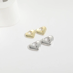 Polished gold and silver broken heart metal hoop earrings for women on white background