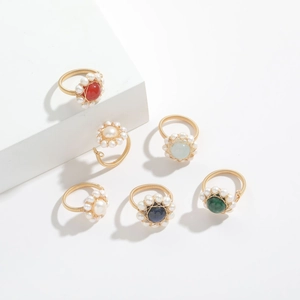 Detail of handmade 14k gold-filled wire wrapped rings with natural stones and pearls