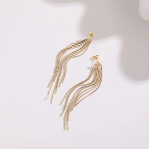 Close-up of golden tassel earrings with multi-strand snake chains and butterfly backings