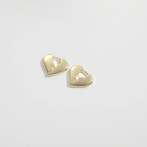 Detailed close-up of broken heart huggie hoop earrings in high-polished gold finish