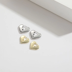 Minimalist broken heart gold and silver hoop earrings on a clean white background