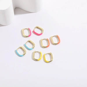 Close-up of four colorful enamel U-shaped gold earrings in pink, orange, blue and yellow